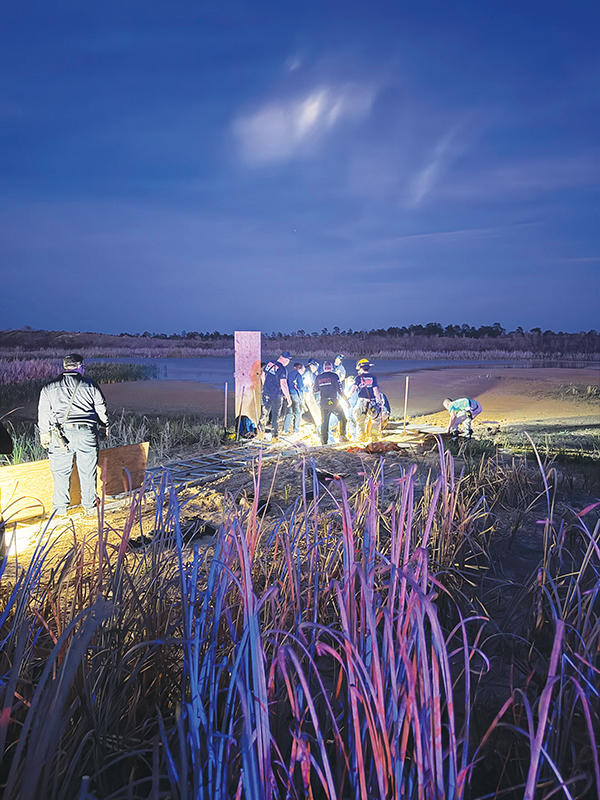A complex setup involving ladders, pallets, ropes and backboards was needed to dig out Jacksonville resident Andrew Giddens from quicksand at a Melrose borrow pit Wednesday night. (Photo submitted by Allison Waters-Merritt)